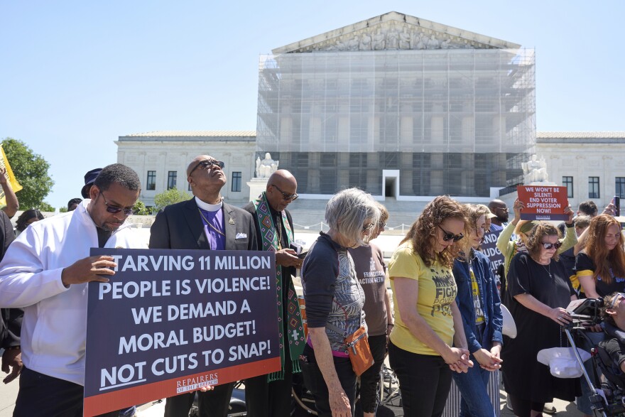 Activists with the Poor People's Campaign protest against spending reductions across Medicaid, food stamps and federal aid in President Donald Trump's spending and tax bill being worked on by Senate Republicans this week, outside the Supreme Court in Washington, Monday, June 2, 2025.
