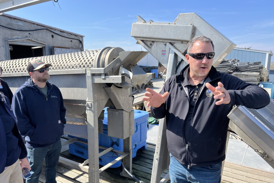 Keith Wilda, co-owner of West Island Oysters, describes the machine behind him, which tumbles oysters to remove the new growth at the edge of the shell and encourage them to grow thick and meaty, rather than too flat — known as "potato chip" oysters.