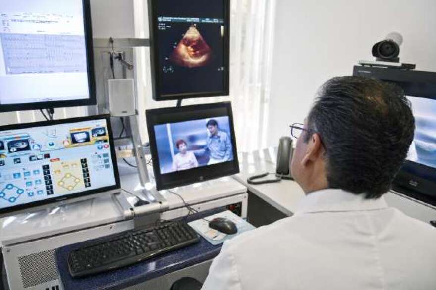  Dr. Juan Manuel Romero, a cardiologist at a hospital in Ciudad Obregon in Sonora, Mexico, engages in a pre-op consultation with Alma Guadalupe Xoletxilva and her doctor, Edgar Cuevas, who are 400 miles away in La Paz, Baja California. Photo: Intel Free Press