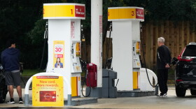 Customers check gas price while they fill up their vehicle's tank at a gas station in Arlington Heights, Ill., Wednesday, Sept. 30, 2026. (AP Photo/Nam Y. Huh)