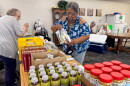 Linda Rufus selects food from the Food Bank of Iowa at an apartment complex in Storm Lake, Iowa, on Thursday, July 16, 2026. Rufus said the pop-up pantry at Storm Lake Senior Living helps her make ends meet.