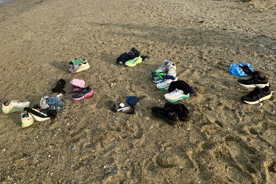 Running shoes and other articles of clothing piled up at East End Beach during a mid-run dip in July.