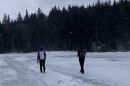 Researchers cross a frozen pond on Saddleback Mountain.