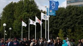 Tribal flags for six of the 11 tribal nations of Minnesota who will be permanently recognized at the state Capitol grounds wave during the Tribal Flag Plaza flag-raising ceremony in St. Paul | MPR News