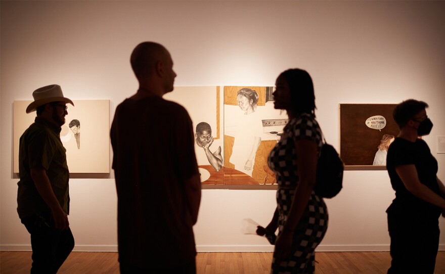 Viewers walk in front of a gallery at UNLV's Barrick Museum.