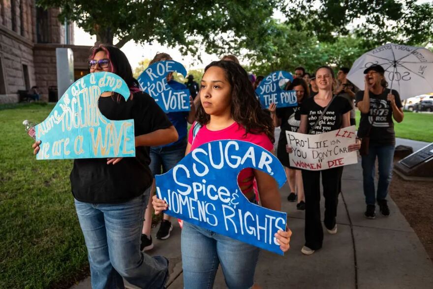  From left: Arianna Reyna, 17, and Alexus Gelacio, 21, march outside of the Tarrant County Courthouse. Gelacio said she wasn’t particularly politically active before the overturning of Roe v. Wade. At the Women’s Wave rally, she decided to register to vote, just a few days before the deadline.