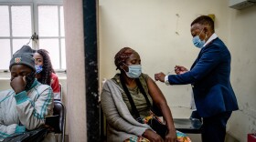 A woman is vaccinated against COVID-19 at a clinic in Johannesburg on Dec. 6. A new study from South Africa looks at the effectiveness of the Pfizer vaccine in preventing infection and severe disease.