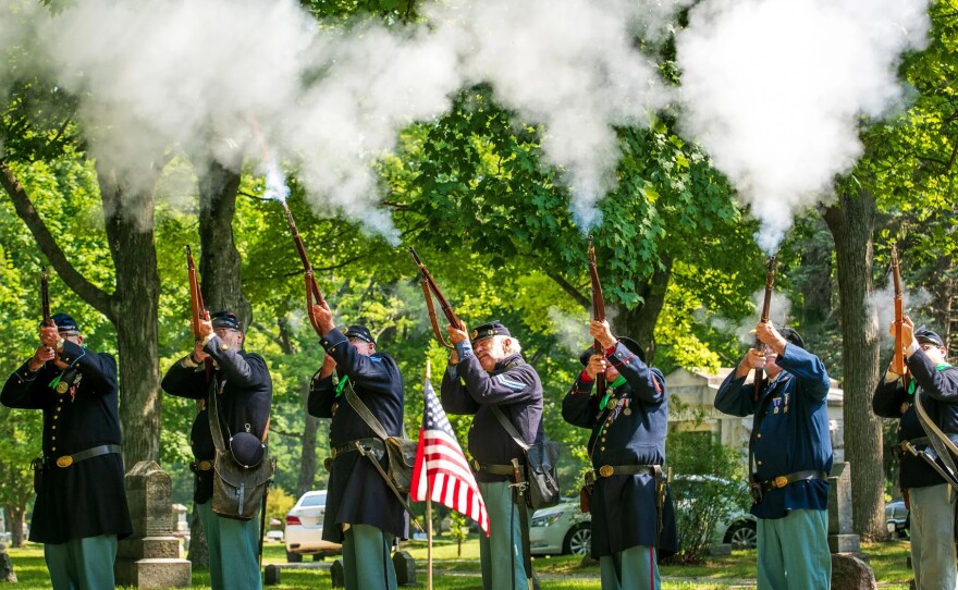 A Sons of Union Veterans of the Civll War honor guard fires a volley during the new gravestone ceremony for Corporal Lyman Snow at Oakwood Cemetery Monday morning in Traverse City. Snow, a veteran of the Mexican-American War and Civil War, received a Veterans Administration headstone this year after 111 years of his grave being unmarked.