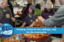 People gather in a cozy, bustling kitchen space at Winter Kissed Farm in Montana’s Bitterroot Valley, preparing kimchi during a traditional Korean kimjang event. In the center, Sohn Jung-a, one of the organizers, smiles while helping mix ingredients in a large metal bowl. Around her, other participants in winter clothing work together, handling napa cabbage coated in red spices. A large tub of kimchi sits in the foreground. A banner reads: "The Big Why – Kimjang: Come for the cabbage, stay for the community."