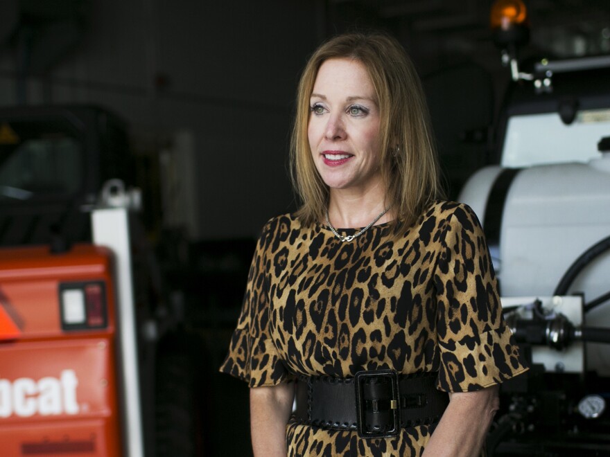 Jo Blondin, president of Clark State Community College, stands in front of precision agriculture machinery in one of the labs on campus in Springfield. She says getting students to stay in the area after graduation is critical to rebuilding the local economy.