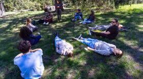 Dr Susan Abookire begins the forest therapy session asking residents and medical student to relax in any way they wish. (Jesse Costa/WBUR)