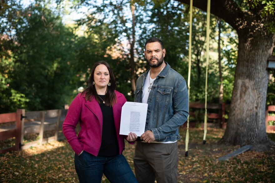 Maria and Miguel Cisneros hold the deed for their house in Golden Valley.