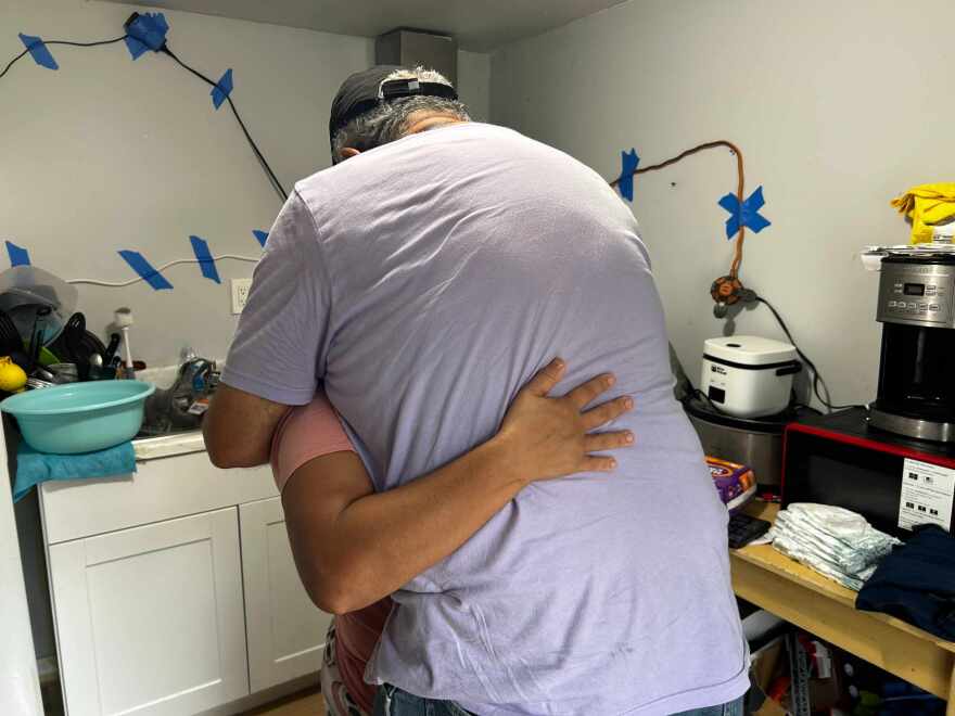 Sigfredo Hernandez comforts Nancy, who moved into a small trailer after her husband was detained by ICE.