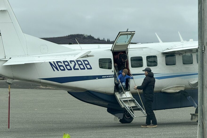 Passengers from Shaktoolik deplane a Wright Air Service Cessna Grand Caravan in Unalakleet on Oct. 11, 2025. The chartered plane came from Fairbanks to help evacuate Shaktoolik residents.