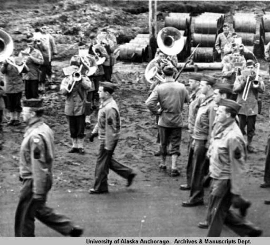 A group of military personnel march past a brass band during a unit dress parade at the 179th Station Hospital, Adak, Alaska, August 1943 - October 1945. Photo: Alaska Digital Archives.