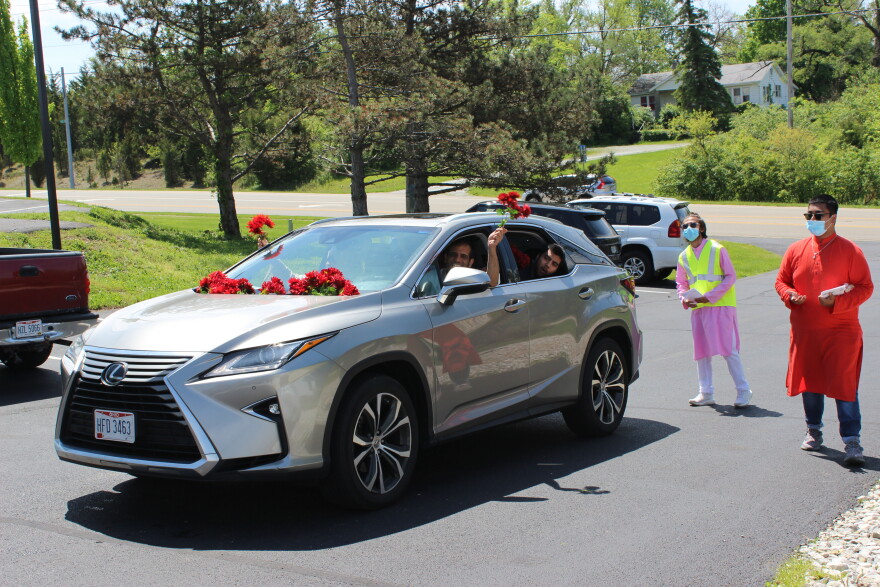 Cars decorated with flowers, streamers, and homemade banners drove through the parking lot at the Dayton Mercy Society's mosque in Miamisburg.