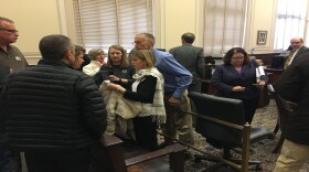 Ron and Jill Plush (far right) are comforted by friends after a hearing in which Cincinnati asked a judge to have their lawsuit over the death of their 16-year-old son dismissed.