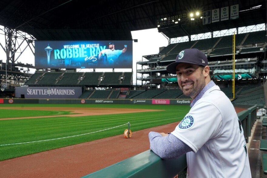 Seattle Mariners pitcher Robbie Ray poses for a photo in the dugout at T-Mobile Park, Wednesday, Dec. 1, 2021, following a news conference in Seattle. The AL Cy Young Award winner — who previously pitched for the Toronto Blue Jays — signed a five-year contract with the Mariners.