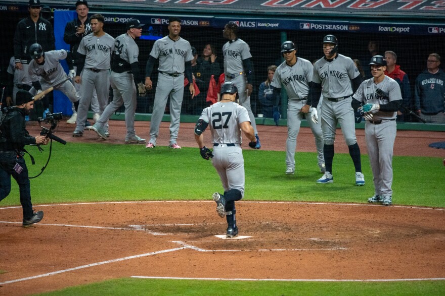 Yankee steps on home plate after home run.
