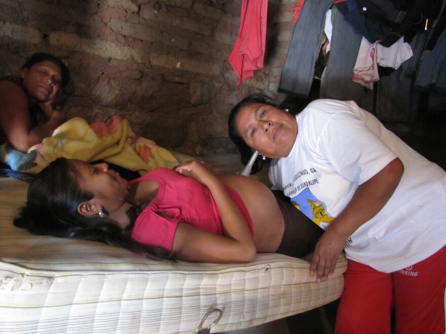 Macrina Martinez listens to an unborn baby's heart beat. She is the village midwife in Tlatquiltzingo, Guerrero.