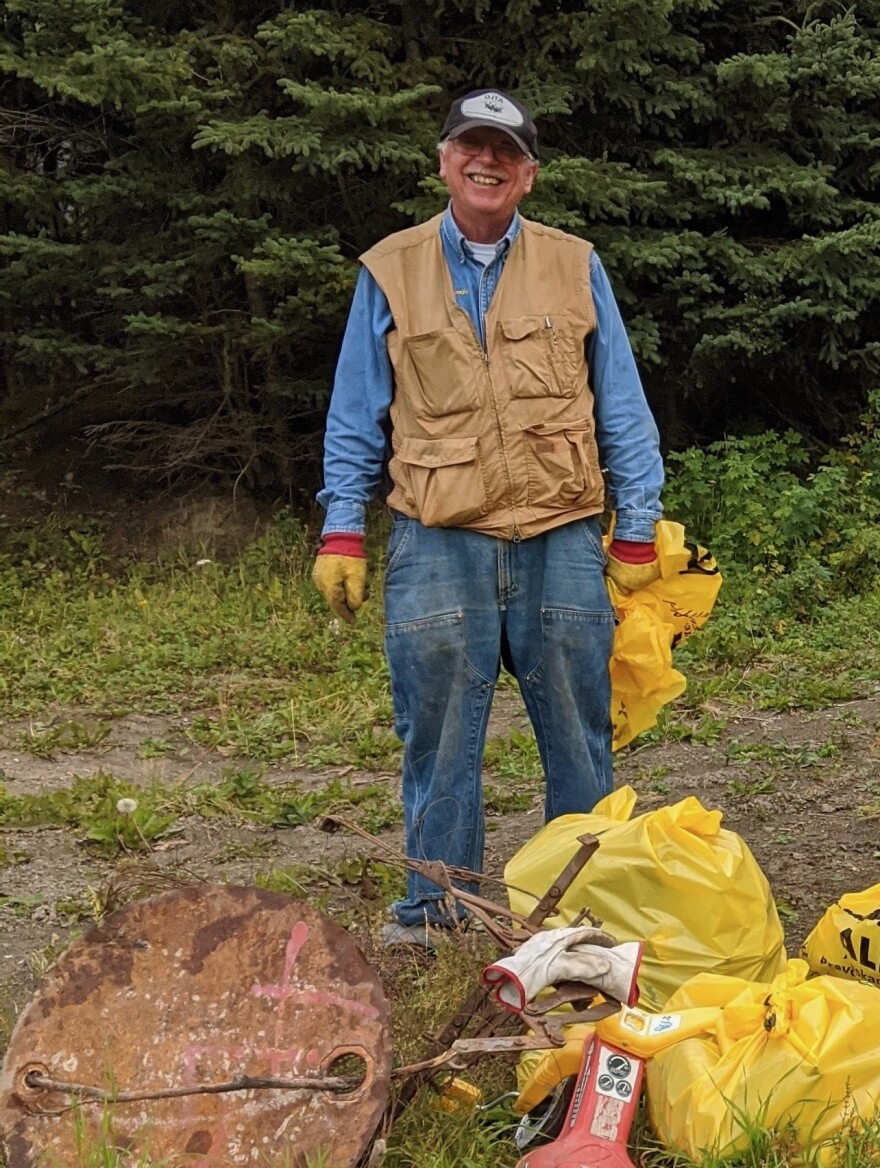 McCombs flashes a satisfied smile and he and other members of the Delta Junction Trails Association cleaned up junk left over from the dumpsite that was located near the River Walk Park before it opened in