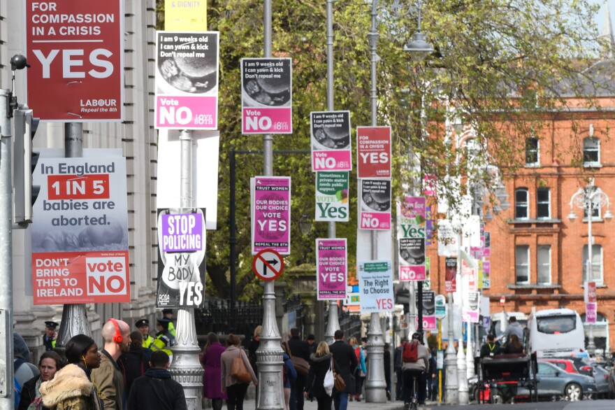 Posters in Dublin's city center urge votes in Friday's referendum.