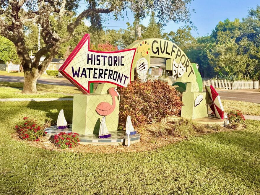 Yellow sign with Gulfport Historic Waterfront 