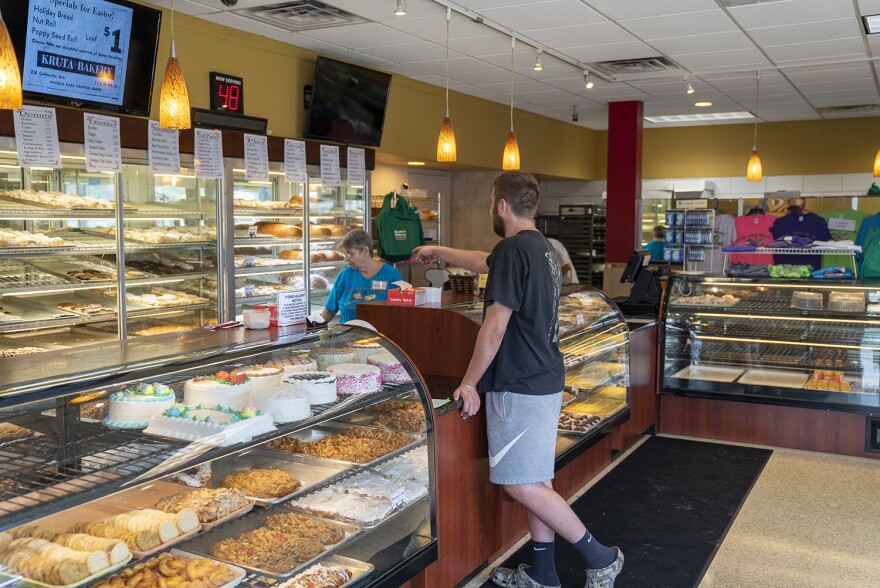A customer at Kruta's Bakery selects a pastry on Aug. 13.