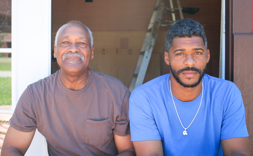 Earlier this summer, Cairo residents Lee Wright and son Roman Wright took a break from their construction work for a photo. Both men had decided not to get vaccinated. "I'm like my dad," Roman Wright says. "I was born and raised in church all my life. So I say we believe in God. I know my parents pray for me. We pray for each other and we just believe in God."