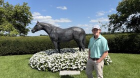 Lane's End's Will Farish stands in front of the AP Indy statue on the farm