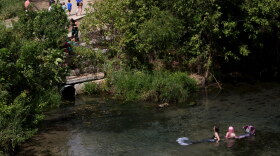 Mermaids float in the San Marcos River during the annual Mermaid Promenade on 2019. 