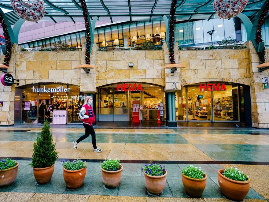 A passer-by walks downtown Rotterdam on December 19, 2021, as the Netherlands have gone into "lockdown" over the Christmas period to try to stop a surge of the Omicron coronavirus variant, Dutch Prime Minister Mark Rutte said on Dec. 18, 2021.