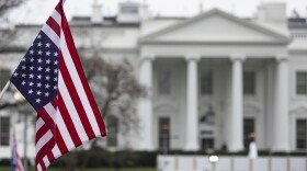 An anti-war protestor holds an upside-down American Flag during a demonstration against war in Iraq and Iran outside the White House on January 4, 2020 in Washington, DC. (Alex Edelman/Getty Images)