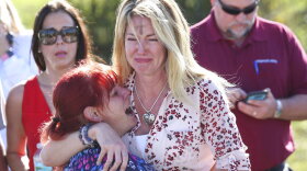 Parents on Wednesday afternoon wait for news after a report of a shooting at Marjory Stoneman Douglas High School in Parkland. (AP Photo/Joel Auerbach)