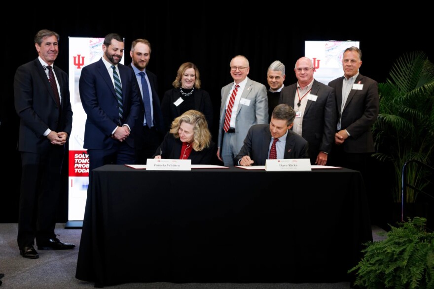 Indiana University President Pamela S. Whitten and Eli Lilly and Company Chair and CEO David Ricks sign an agreement during an event at IU Indianapolis on Wednesday, Dec. 3, 2025.