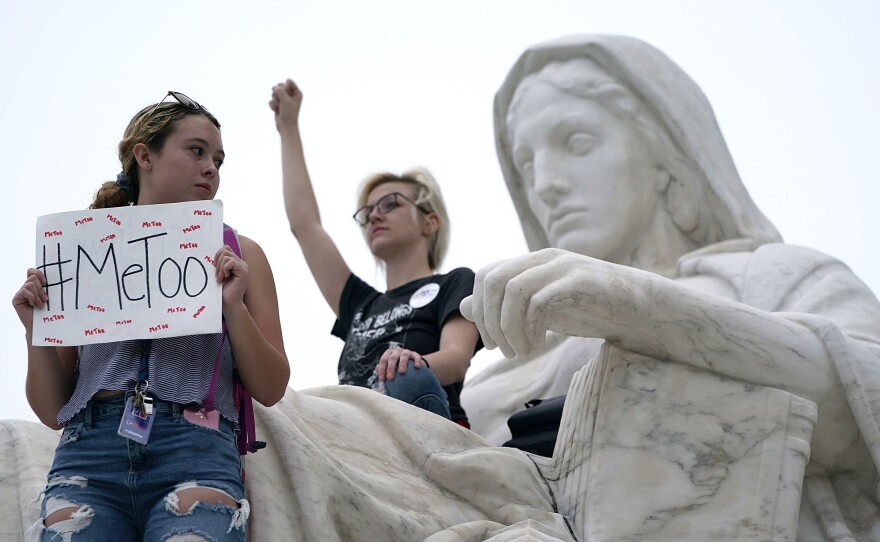 Protesters occupy the <em>Contemplation of Justice</em> statue in front of the Supreme Court Saturday after Kavanaugh was confirmed.