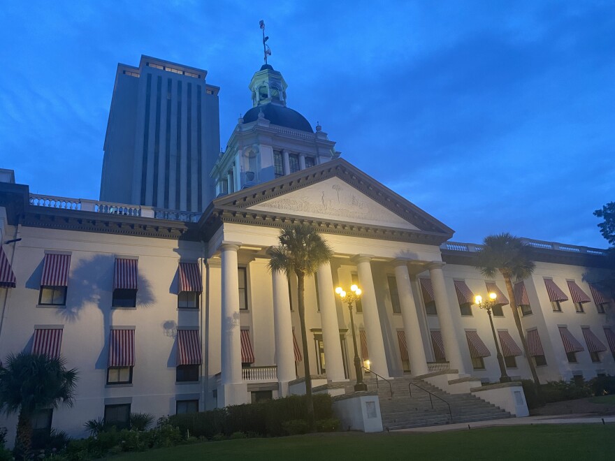 old florida capitol building white with striped awnings