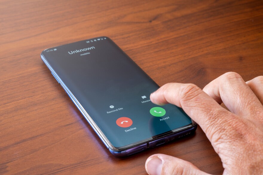 Phone screen shows unknown number calling