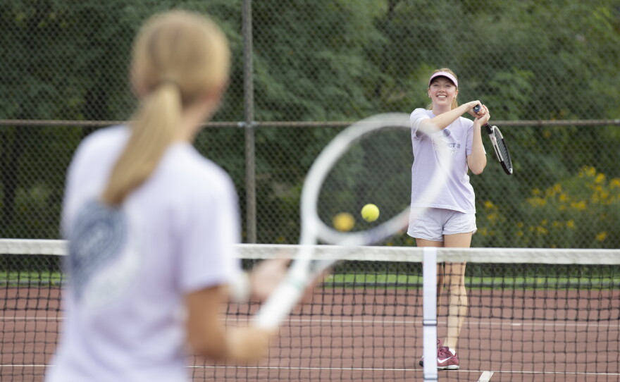 Anna and Cara Evans, both members of the Montrose girls tennis team, practice together.