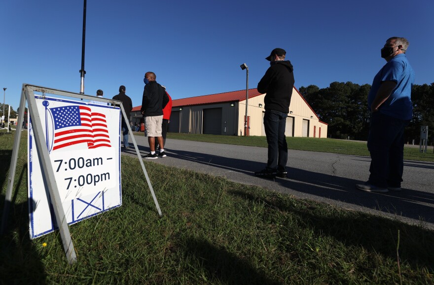 Voters line up at Gwinnett County Fairgrounds last month in Lawrenceville, Ga., to cast their ballot on the final day of early voting in Georgia.