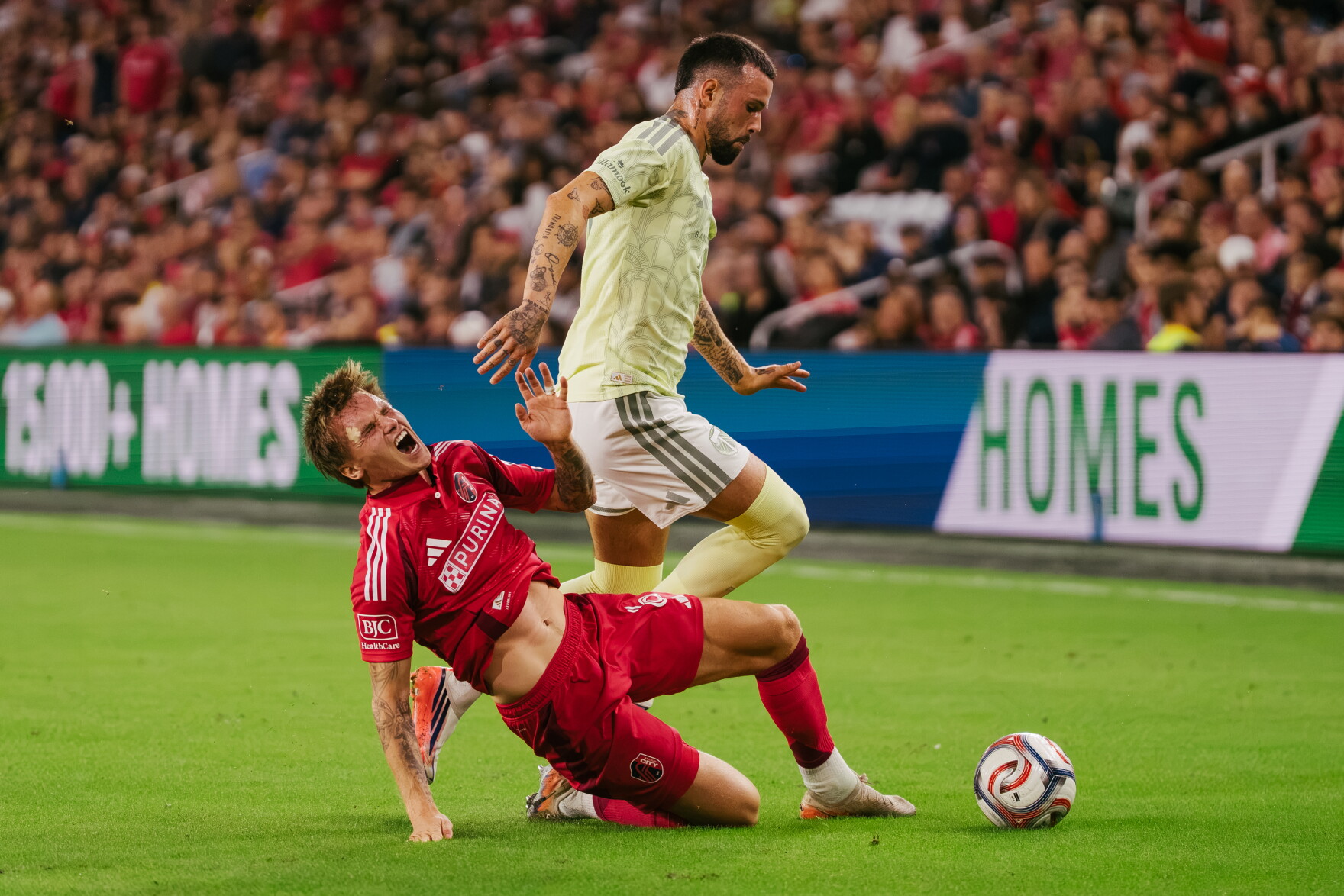St. Louis City SC midfielder Carlo Holse (#19) falls to the turf while challenging Portland Timbers forward Kristoffer Velde (#99) for the ball during their match on Wednesday, Oct. 28, 2026, at Energizer Park in St. Louis’ Downtown West neighborhood.