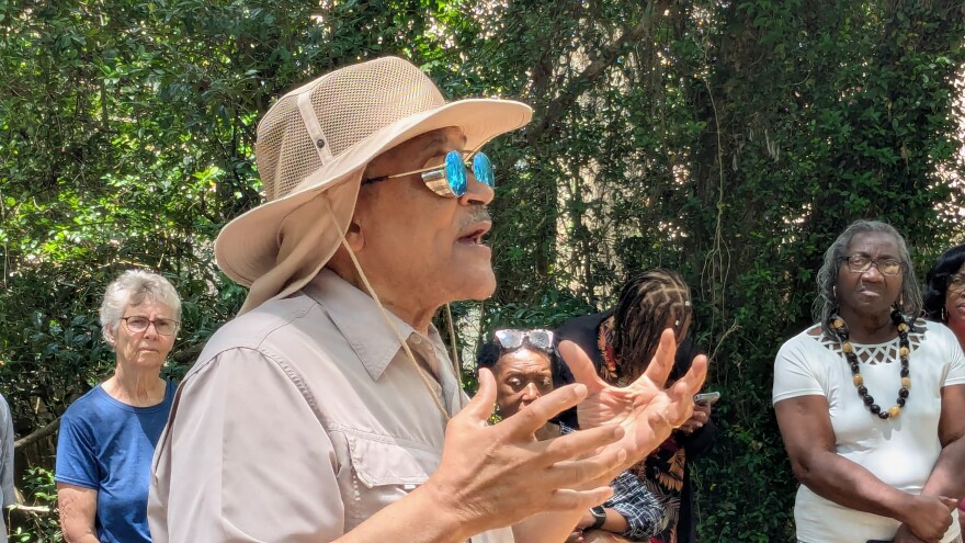 Tallahassee historian Dr. Larry Rivers speaks to the visitors at the Betton Hills cemetery.