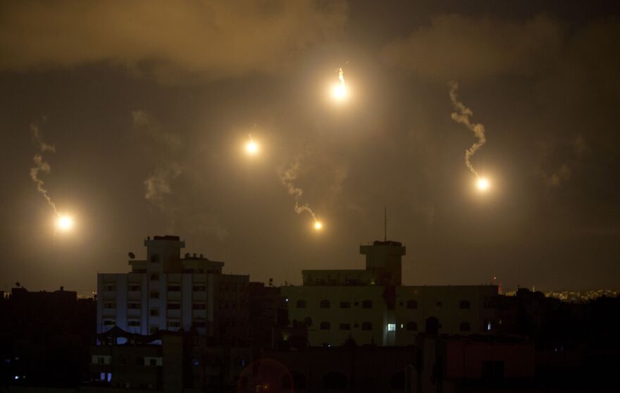 Israeli army flares illuminate the sky above the Gaza Strip on July 18. After waging an air campaign initially, Israel has sent ground troops into the territory.