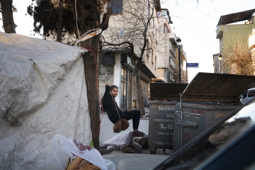 Reyen Nahsen, 13, swings on a makeshift swing made of rope and a pillow.