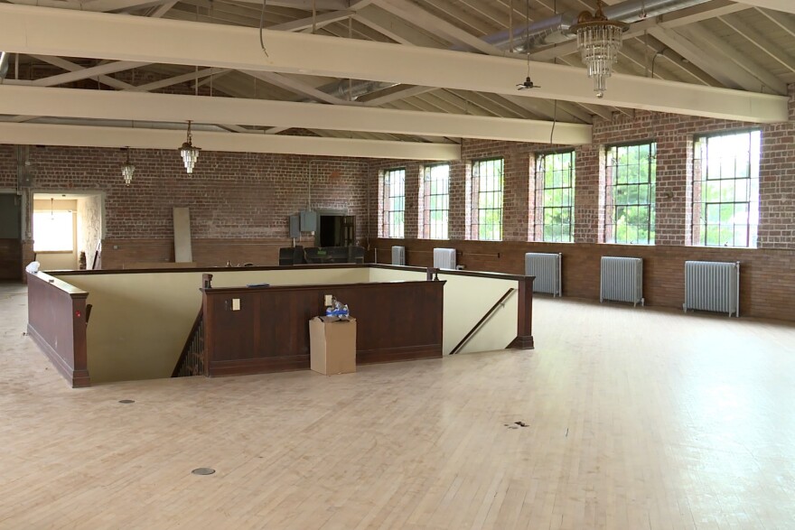 An empty warehouse space with hardwood floors