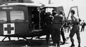 A San Antonio-based MAST crew loads a patient onto a medevac helicopter around 1970. The MAST program was designed to bring battlefield emergency medical techniques to civilians in the U.S.