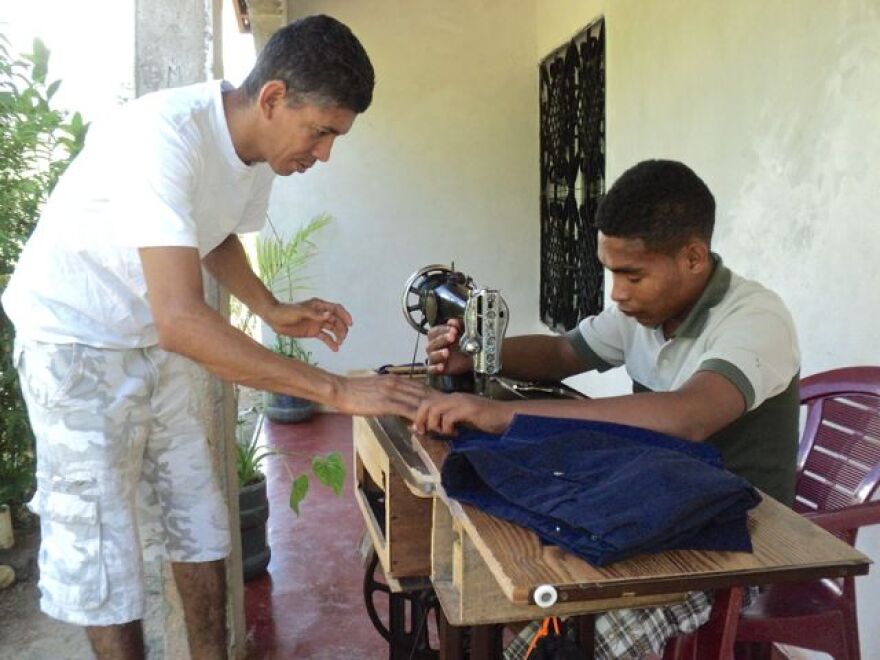 Ostin works to teach tailoring to Chemo (right).