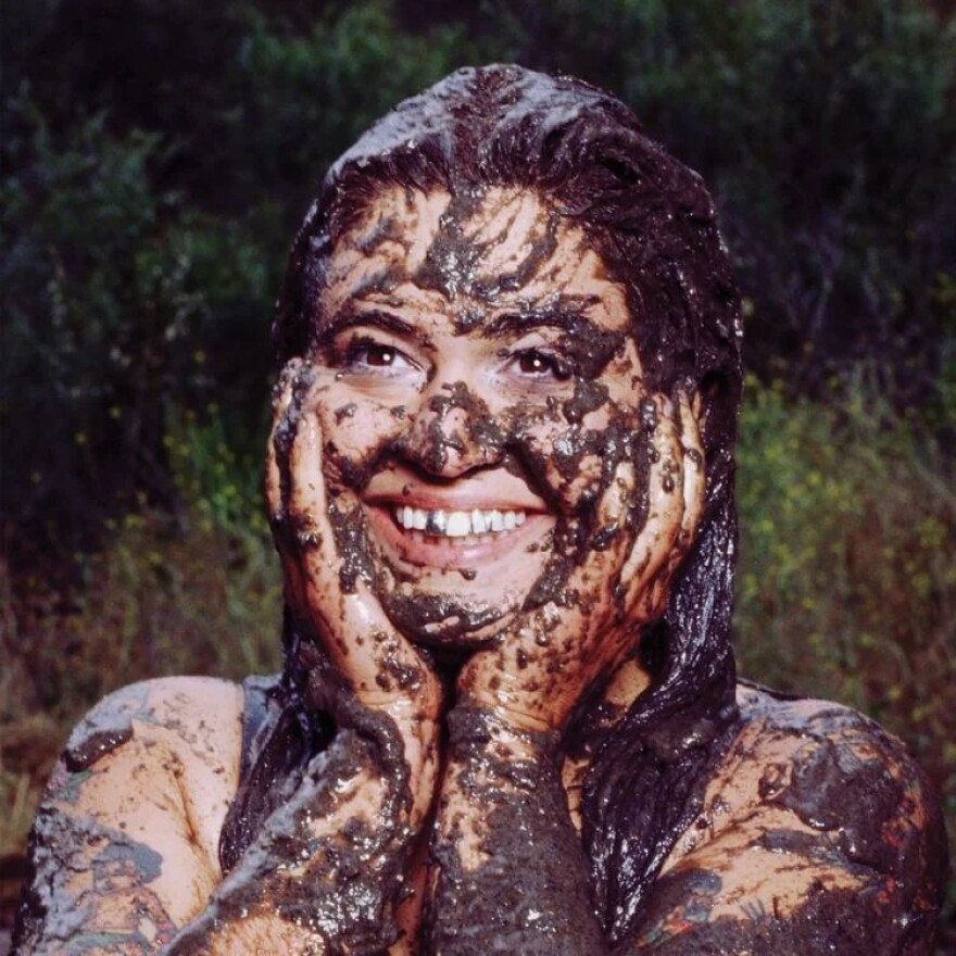 a woman covered in mud 