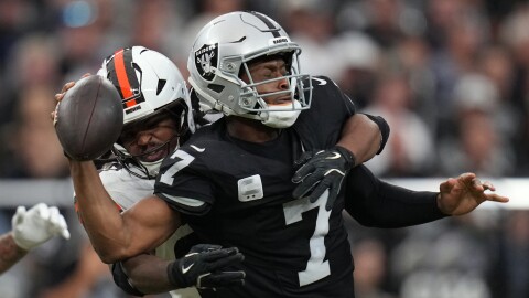 Cleveland Browns linebacker Devin Bush (30) sacks Las Vegas Raiders quarterback Geno Smith (7) during the first half of an NFL football game Sunday, Nov. 23, 2025, in Las Vegas. (AP Photo/Eric Gay)