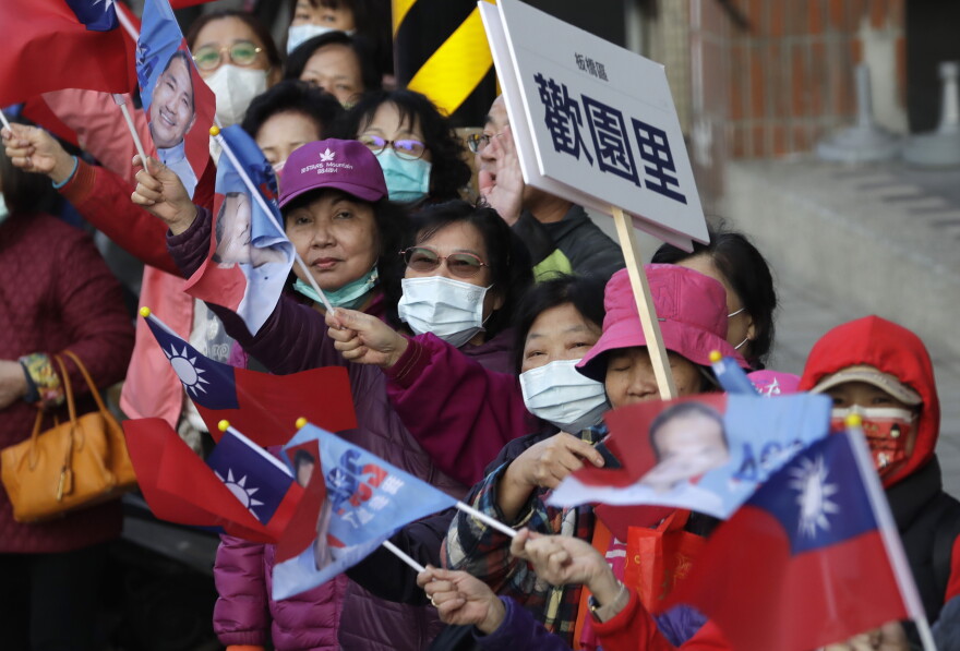 Supporters of Taiwan's Nationalist Party presidential candidate Hou Yu-ih cheer during his car campaign in New Taipei, Taiwan, Thursday, Jan. 11, 2024. Taiwan will hold its presidential election on Jan. 13. 